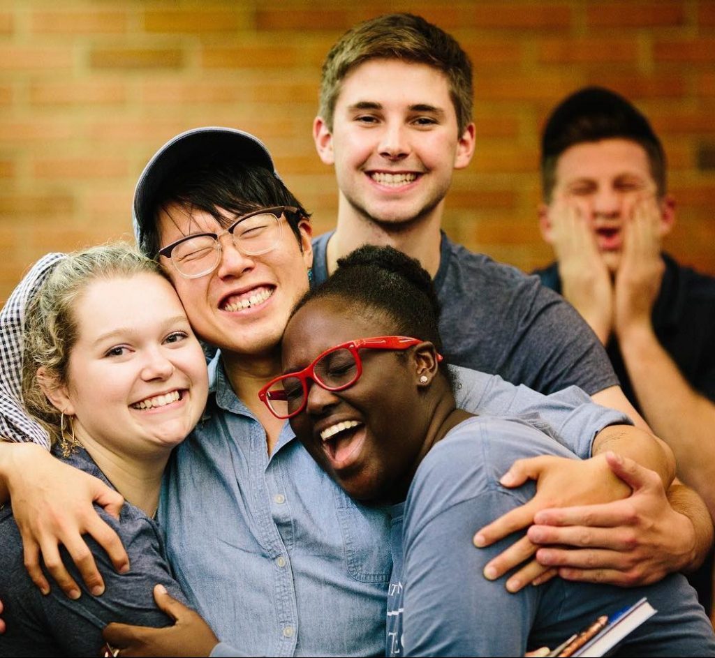 Group of students hugging and smiling